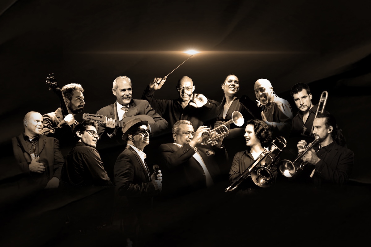 Cuban band Buena Vista All Stars posing together with musical instruments in sepia lighting.